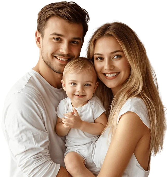 A smiling mother and father holding their toddler, all wearing white shirts